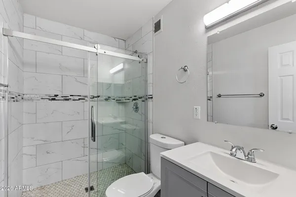 a bathroom with a sink toilet and shower