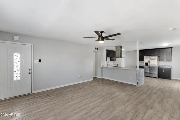 a large kitchen with stainless steel appliances granite countertop a stove a sink and a refrigerator
