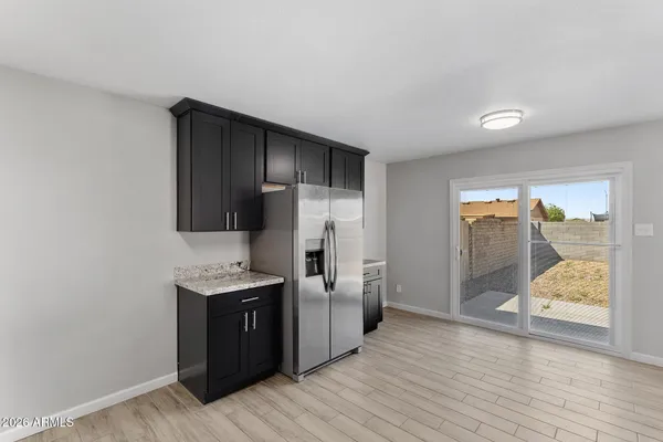 a view of a kitchen with a sink wooden floor and a living room