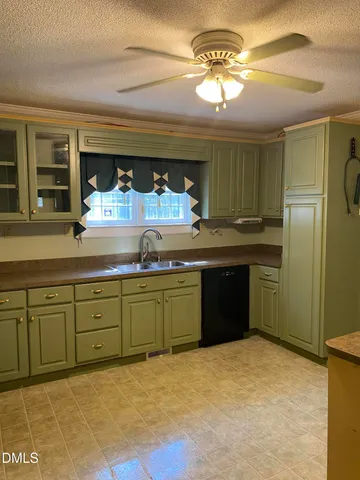 a kitchen with a sink refrigerator and cabinets