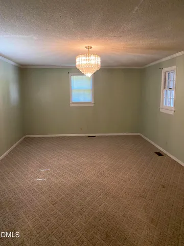 an empty room with a empty space and a window