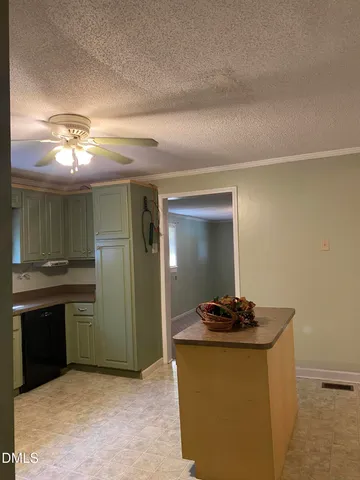 a kitchen with kitchen island stainless steel appliances a sink and a refrigerator