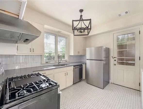 a kitchen with a refrigerator a sink and a stove