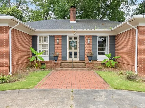 a view of a house with table and chairs in patio