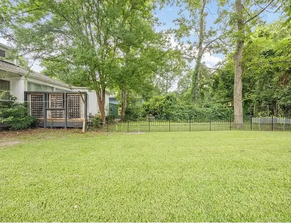 a view of a backyard with a garden and entertaining space