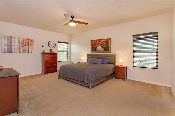 a bedroom with a large bed and a chandelier