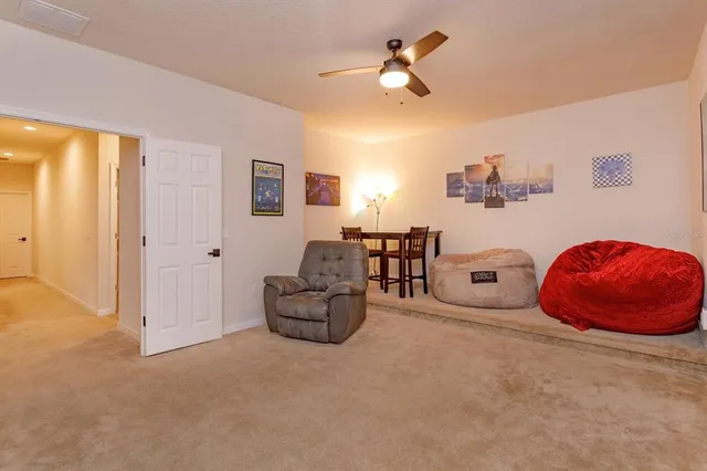 a living room with furniture and ceiling fan