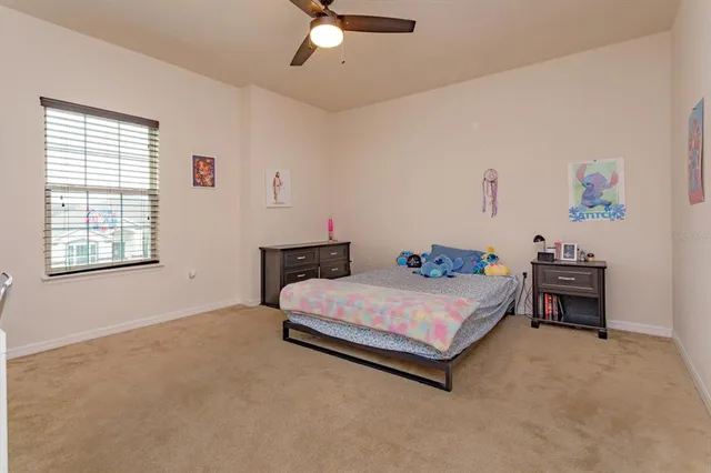 a bedroom with a bed table and window