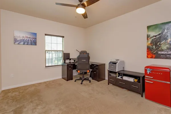 a view of a workspace with furniture and a window