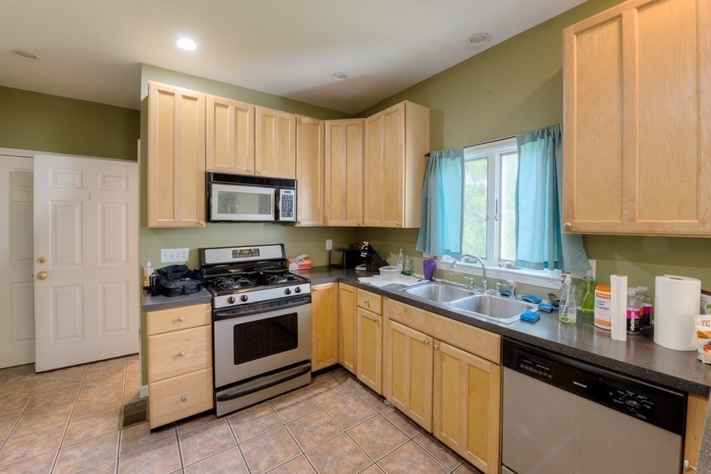 407-9 Sumner Avenue Springfield, MA 01108 - Photo 22 of 40 a kitchen with a stove a sink and a microwave