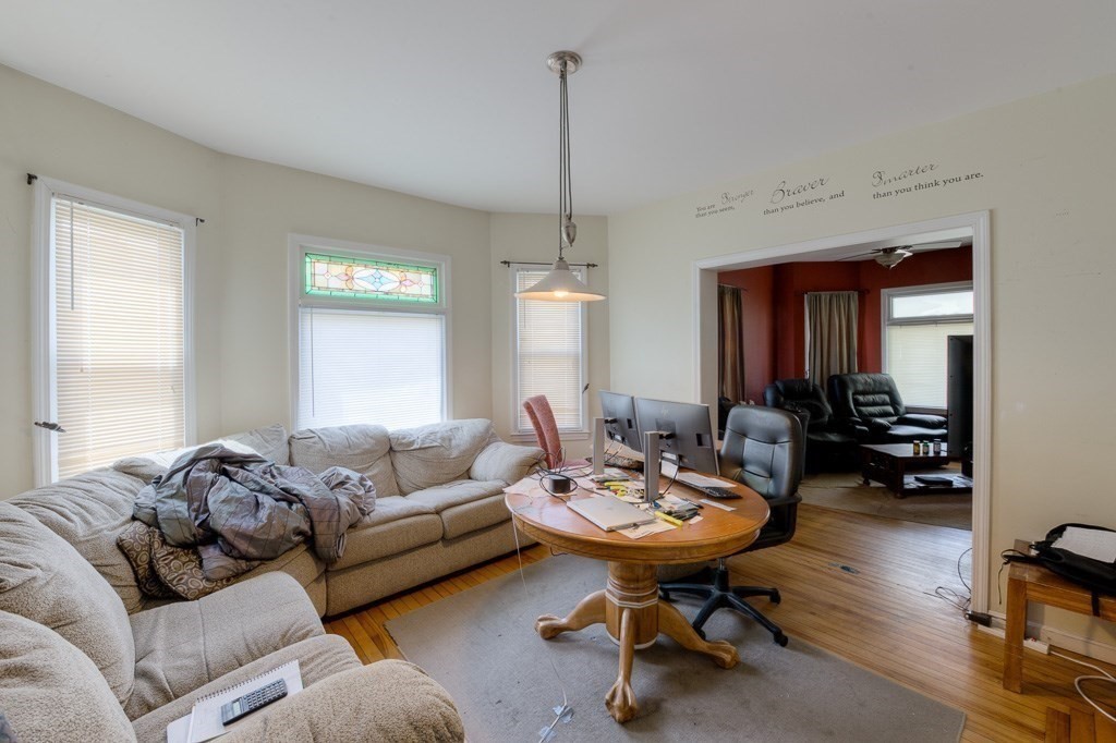 407-9 Sumner Avenue Springfield, MA 01108 - Photo 23 of 40 a living room with furniture a rug and a chandelier