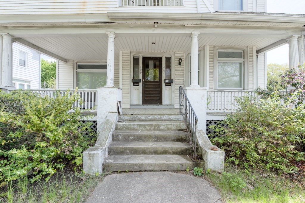 407-9 Sumner Avenue Springfield, MA 01108 - Photo 40 of 40 a view of a house with large windows and a flower plants