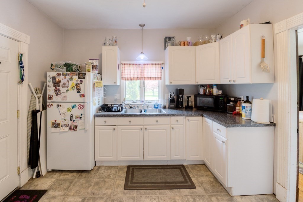 407-9 Sumner Avenue Springfield, MA 01108 - Photo 8 of 40 a kitchen with stainless steel appliances a refrigerator sink and cabinets