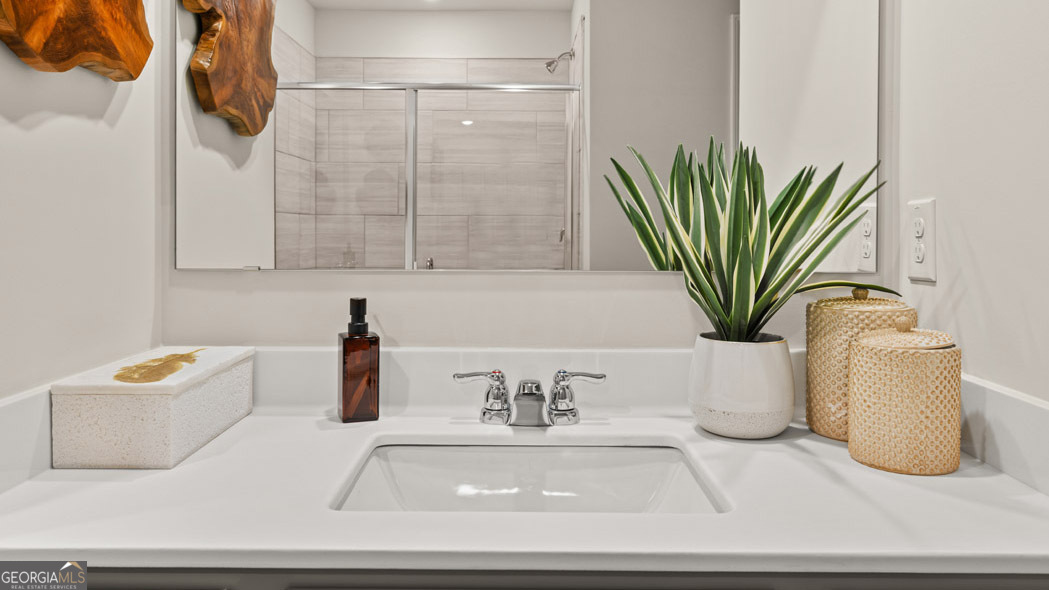404 Reflection Drive Stockbridge, GA 30281 - Photo 45 of 57 a bathroom with a potted plant and a sink