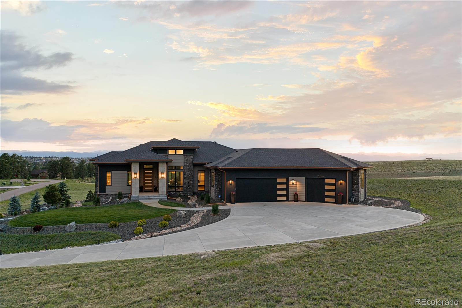 10689 Shadow Pines Road Parker, CO 80138 - Photo 2 of 50 a front view of a house with garden
