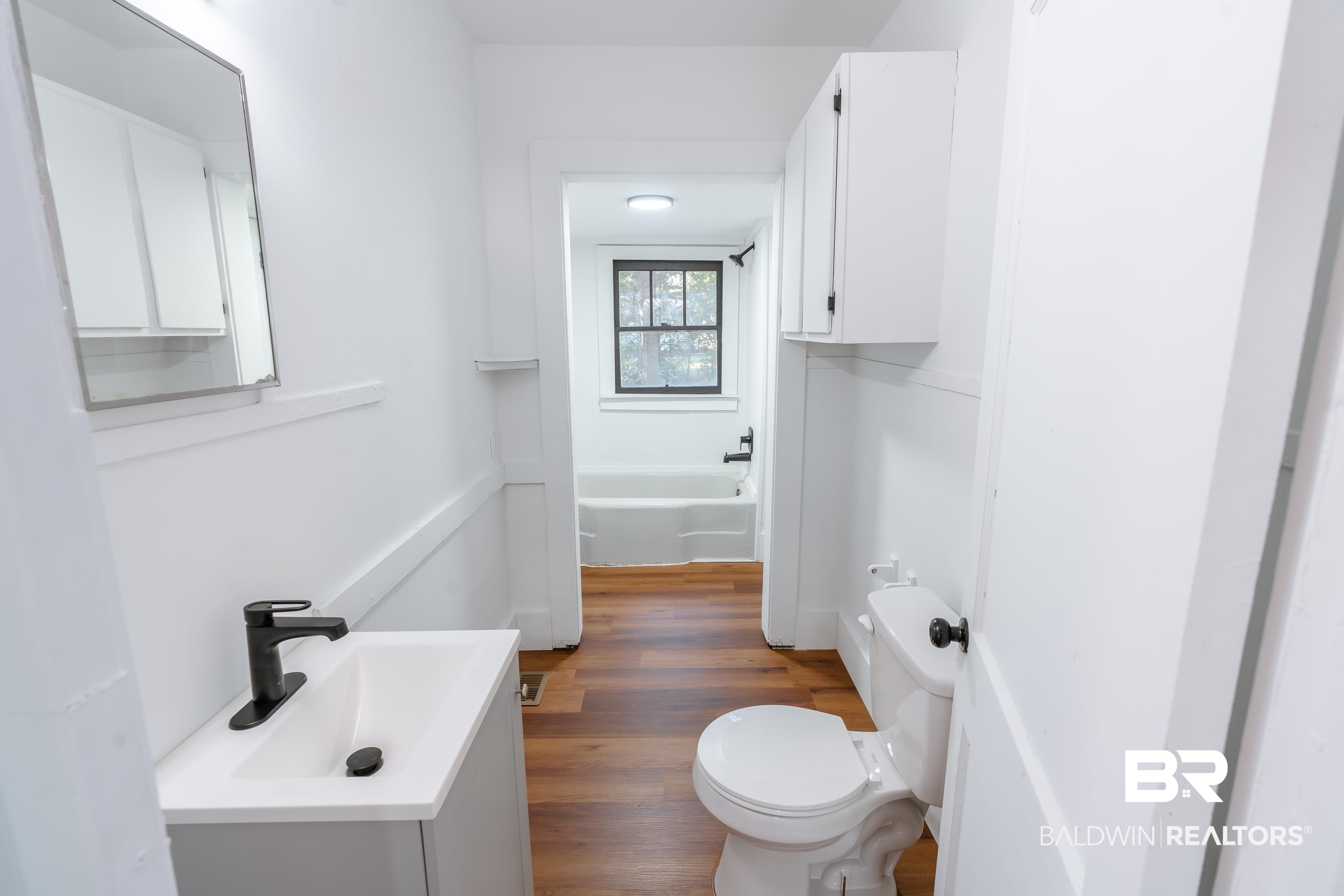 166 Crenshaw Street Mobile, AL 36606 - Photo 11 of 24 Bathroom with a bath, toilet, hardwood / wood-style flooring, and vanity