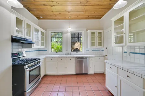 a kitchen with a sink stove and cabinets