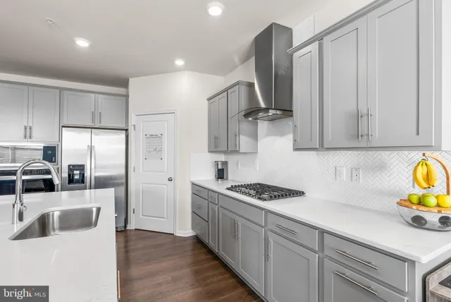 a kitchen with granite countertop a sink and a stove top oven