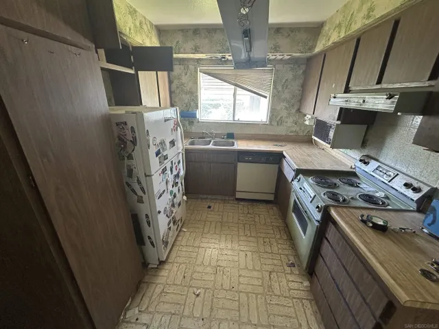 a kitchen with a refrigerator and a stove