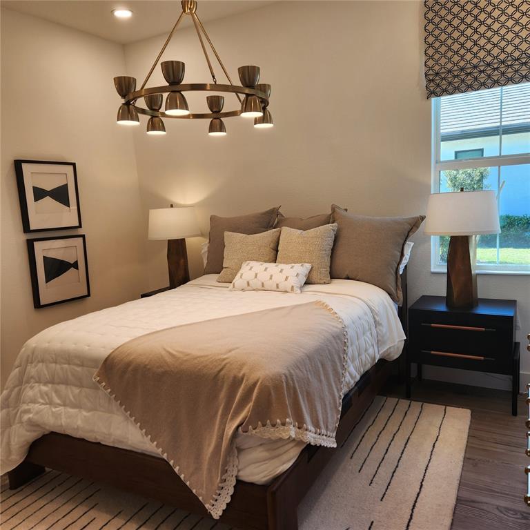 512 Blue Shell Loop Sarasota, FL 34240 - Photo 11 of 15 a bedroom with a bed and wooden floor