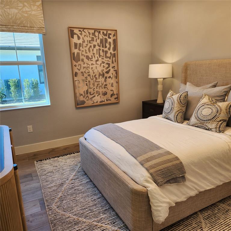 512 Blue Shell Loop Sarasota, FL 34240 - Photo 12 of 15 a bedroom with a bed and a window