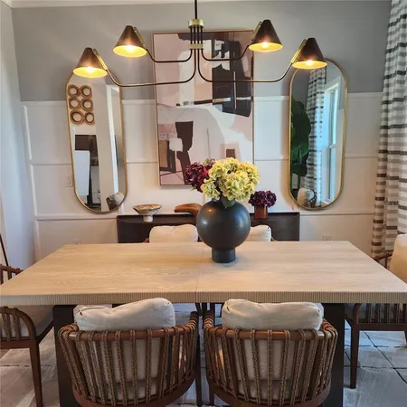 a kitchen with stainless steel appliances granite countertop a stove a sink and white cabinets