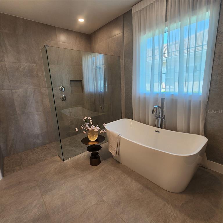 512 Blue Shell Loop Sarasota, FL 34240 - Photo 9 of 15 a white bath tub sitting in a bathroom