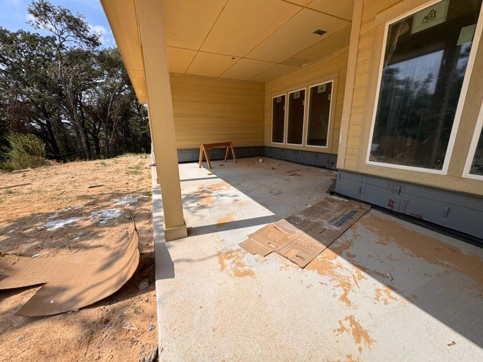121 Oak Grv Way Springtown, TX 76082 - Photo 11 of 13 Covered concrete patio with horizontal siding and multiple large windows