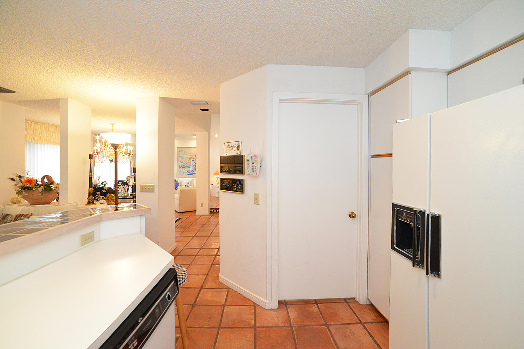 2168 Northwest 53rd Street Boca Raton, FL 33496 - Photo 12 of 31 a large white kitchen with stainless steel appliances a refrigerator a stove a microwave and living room view