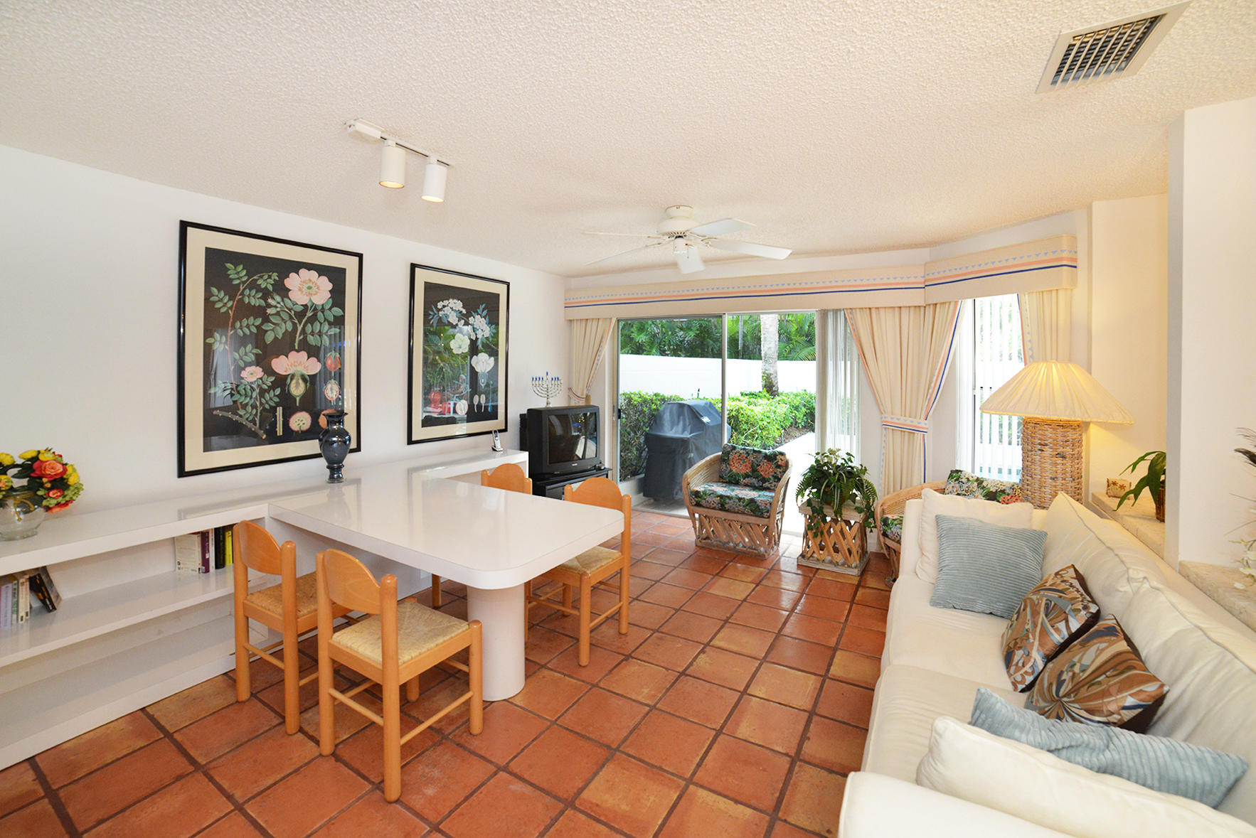 2168 Northwest 53rd Street Boca Raton, FL 33496 - Photo 13 of 31 a living room with furniture a large window and dining table