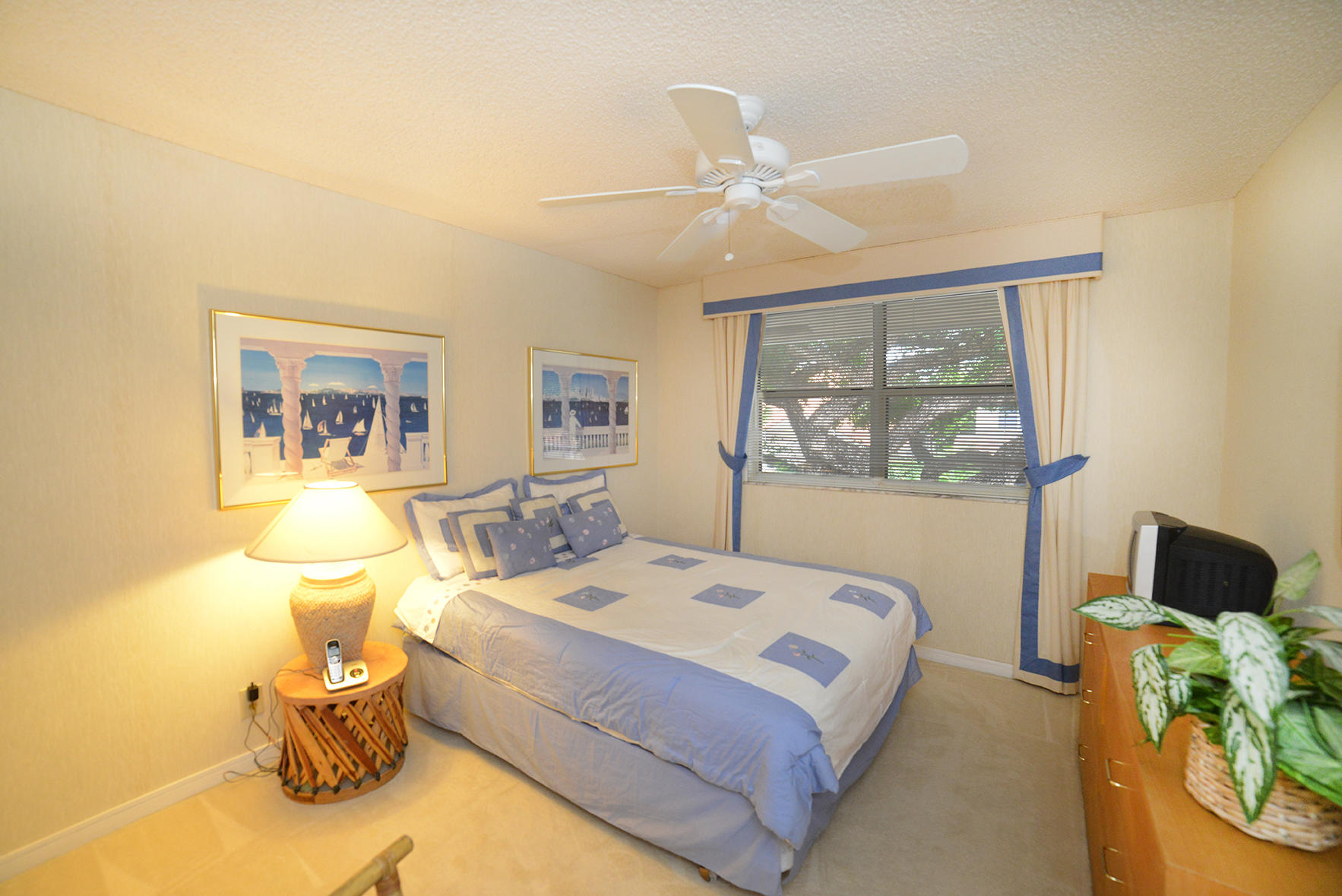 2168 Northwest 53rd Street Boca Raton, FL 33496 - Photo 16 of 31 a bedroom with a bed and lamp