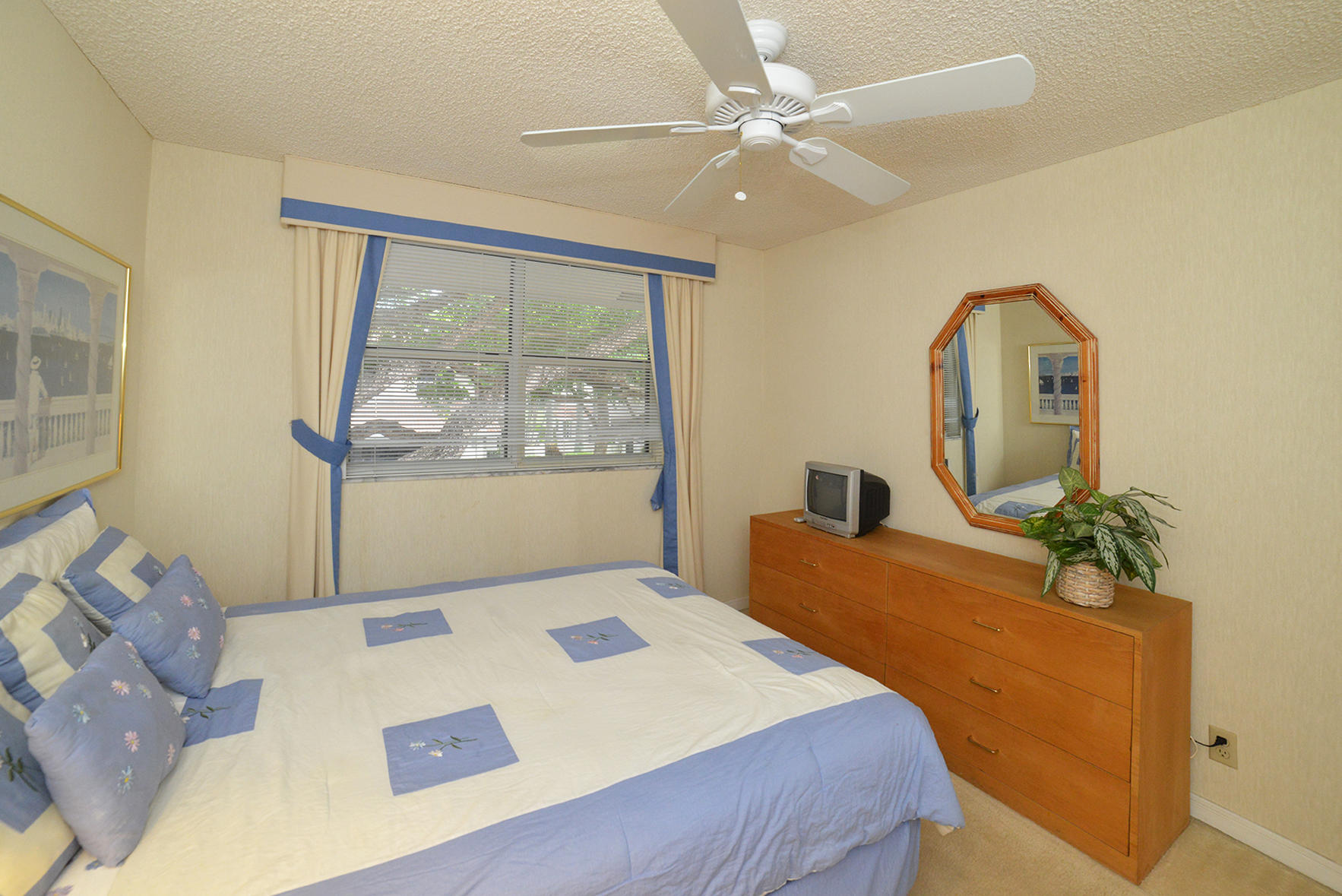 2168 Northwest 53rd Street Boca Raton, FL 33496 - Photo 17 of 31 a bedroom with a large bed and a chandelier