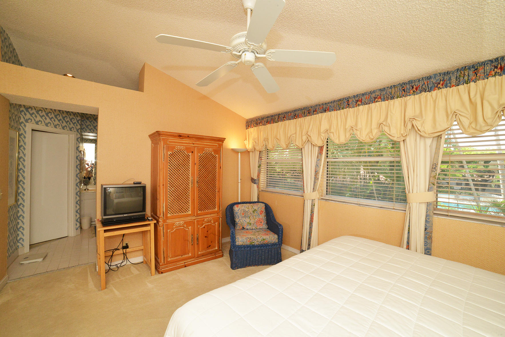 2168 Northwest 53rd Street Boca Raton, FL 33496 - Photo 21 of 31 a bedroom with a bed and a large window with the outer view