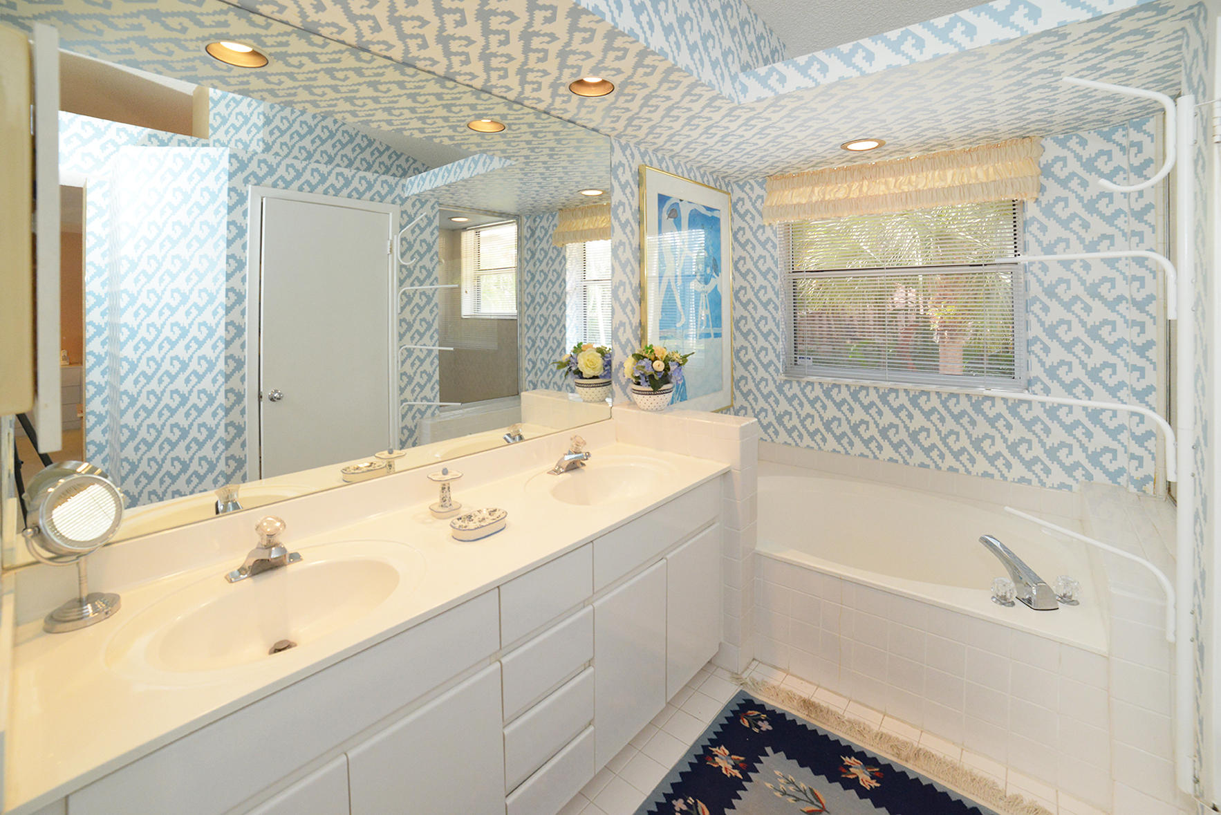 2168 Northwest 53rd Street Boca Raton, FL 33496 - Photo 22 of 31 a bathroom with a tub sink and mirror