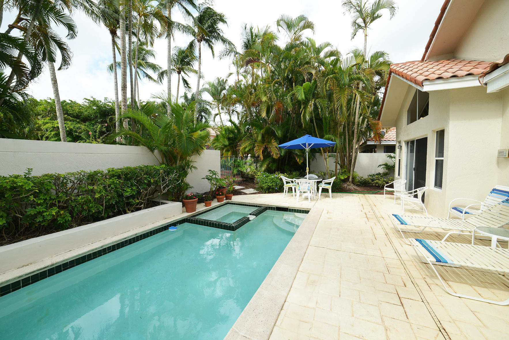 2168 Northwest 53rd Street Boca Raton, FL 33496 - Photo 25 of 31 a view of a swimming pool with a patio