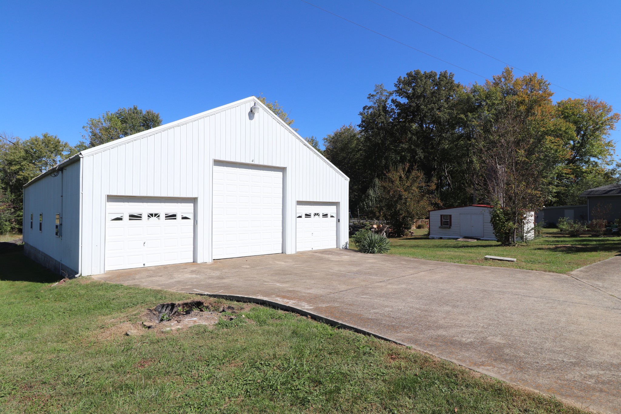 304 Church Street Lafayette, TN 37083 - Photo 8 of 9 a view of a house with a yard and garage
