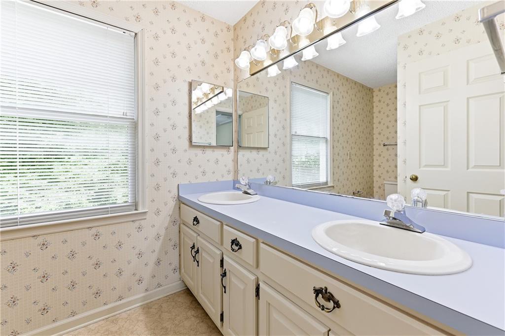 3608 Maple Forge Lane Gainesville, GA 30504 - Photo 31 of 45 a bathroom with a sink a vanity and a mirror