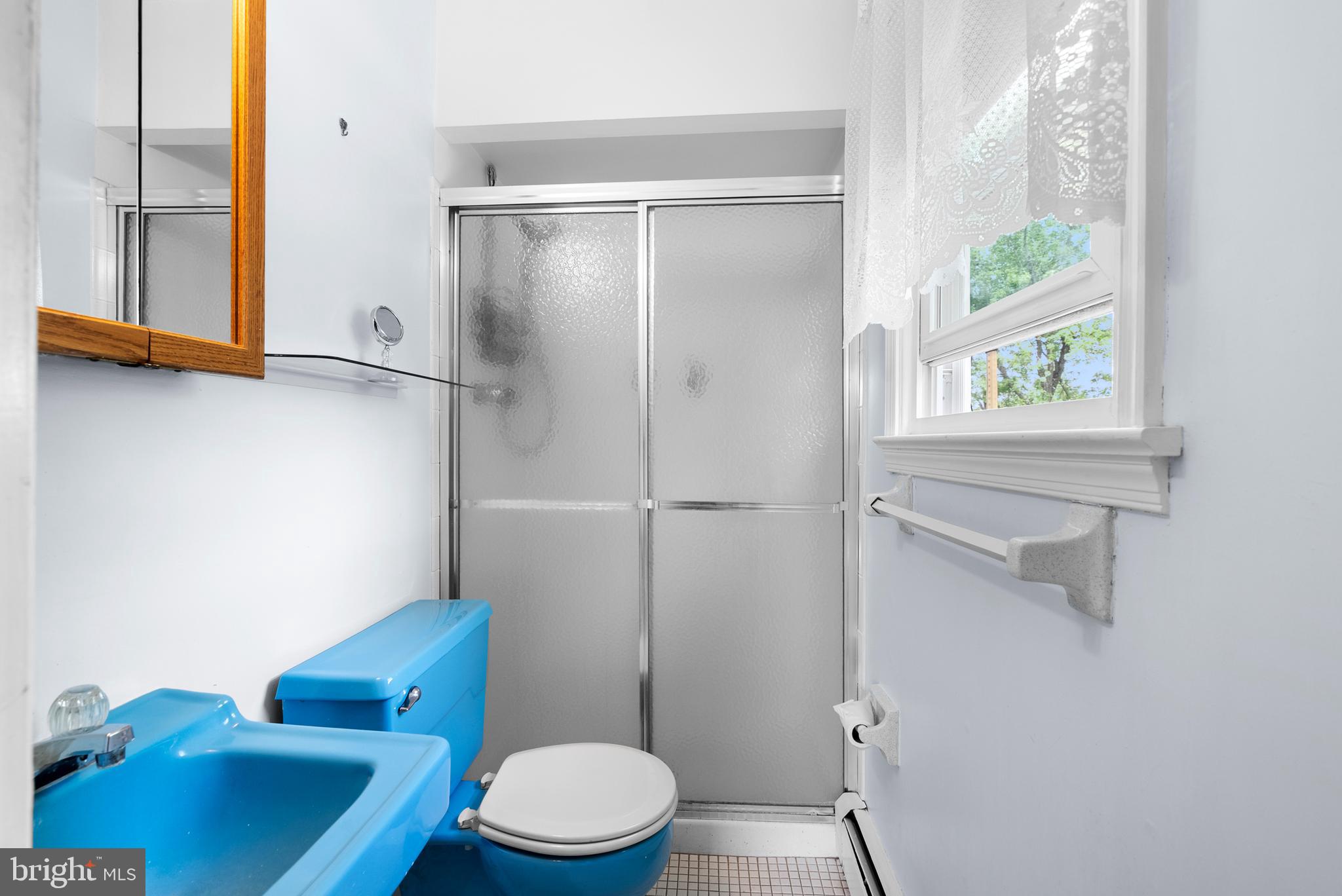 2235 South County Line Road Telford, PA 18969 - Photo 43 of 63 a white toilet sitting next to a bathroom sink and tub