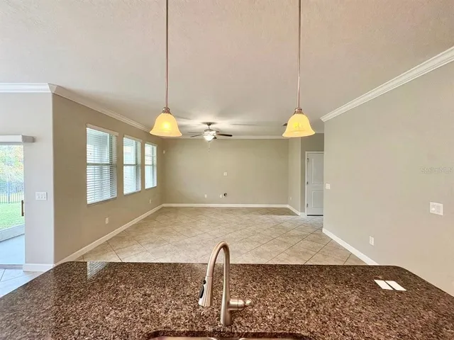 a view of a room with a ceiling fan