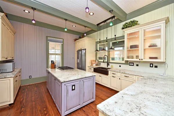 a kitchen with a stove a sink and a refrigerator