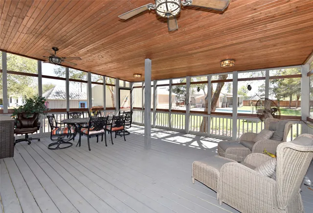 a view of a backyard with a small cabin and wooden fence