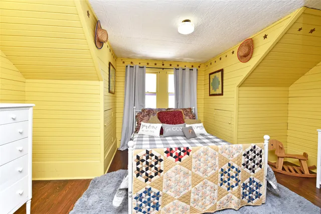 a kitchen with granite countertop a stove a sink dishwasher and a refrigerator with wooden floor