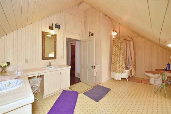 a spacious bathroom with a double vanity sink a mirror and a bathtub