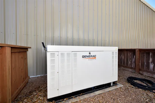 a bedroom with a bed and a night stand with wooden floor