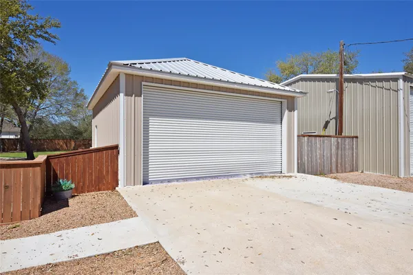 a view of a brick house with a large tree