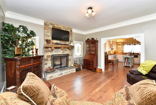 a kitchen with stainless steel appliances a stove a sink dishwasher and white cabinets with wooden floor