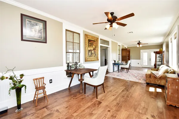 a living room with furniture a rug and white walls