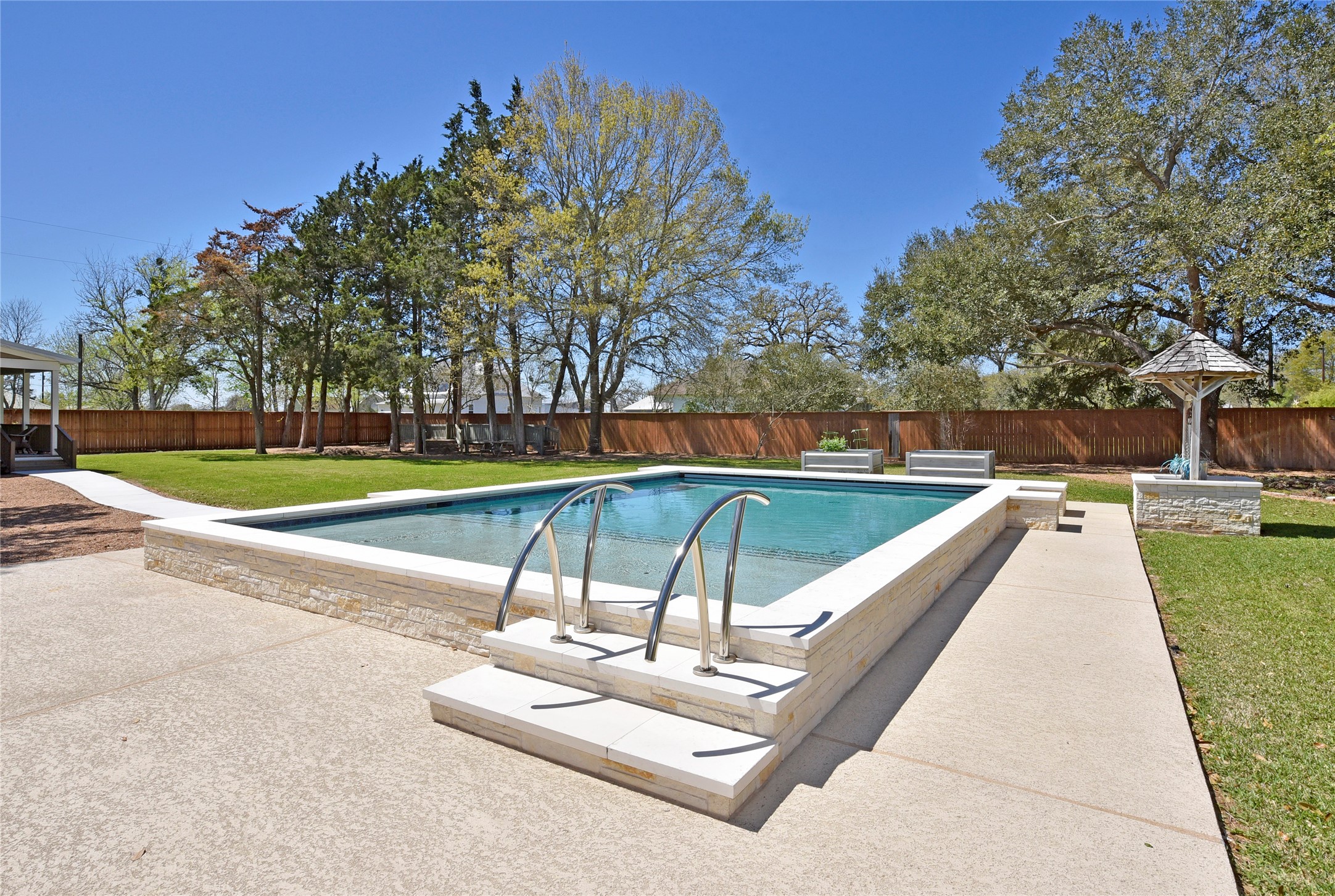 315 Cedar Street New Ulm, TX 78950 - Photo 5 of 50 a swimming pool with outdoor seating and yard