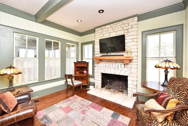 a living room with furniture fireplace and flat screen tv