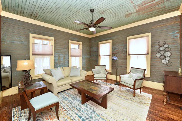 a living room with furniture a chandelier and a window
